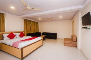 a hotel room with a bed and a television at Hotel Orbit Inn Near Infiniti Mall in Mumbai