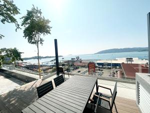 a balcony with two benches and a view of the water at The Shore Kota Kinabalu City Centre by LW Suites in Kota Kinabalu