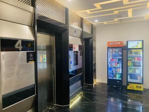 a gas station with two vending machines in a building at YueShe Apartment - HongQiao Longbai Xincun in Shanghai