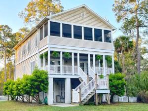 a large white house with a porch and stairs at 4bed/4bath Home + Spa Midway to Savannah & Tybee Island in Savannah