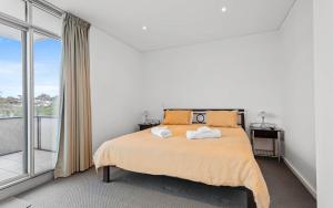 a bedroom with a bed and a large window at 412, 162 Hindmarsh Rd, Victor Harbor in Victor Harbor