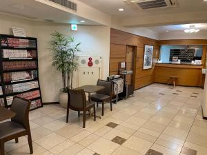 a waiting area of a library with a table and chairs at Kawasaki Hotel Park - Vacation STAY 02891v in Kawasaki