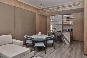 a dining room with a table and chairs and a kitchen at Crowne Plaza Ganzhou, an IHG Hotel in Ganzhou