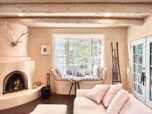 Una sala de estar con un sofá y una chimenea. en Casa TATIZ • Privacy in a Southwestern Gem, en Santa Fe