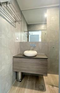 a bathroom with a sink and a mirror at Sydney RiseOn Hotel in Sydney