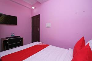 a bedroom with purple and white walls and a bed at Flagship Hotel Magadh Empire in Patna