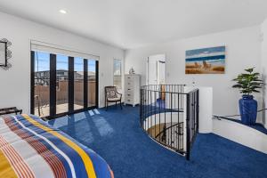 a bedroom with a bed and a balcony at Poolside Serenity - Papamoa Beach Holiday Home in Papamoa +21 photos