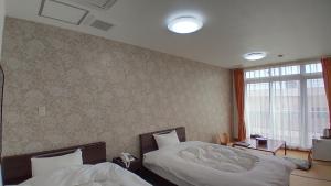 Katil atau katil-katil dalam bilik di Esperanza Resort Atami-エスペランサリゾート熱海