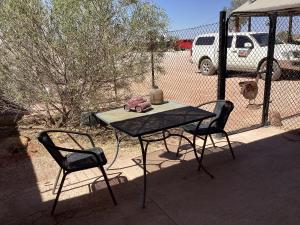 a table and two chairs on a patio at Pop’n’nin Dugout Accommodation at Coober Pedy Views in Coober Pedy