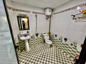 a bathroom with a toilet and a sink at Manh Vuong Hotel CatBa in Cat Ba +82 photos