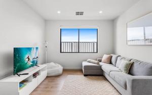 a living room with a couch and a tv at Golden Views at Normanville 36 Union Road in Normanville