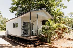 a small white tiny house with a porch at BIG4 Breeze Holiday Parks - Katherine in Katherine