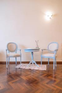 a dining room with two chairs and a table at La Loggia del Mercante in Orvieto +20 photos