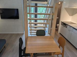 a kitchen and dining room with a table and chairs at Summit Chalets in Hakuba