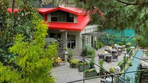 a house with a red roof and a patio at 7 Pines Kasauli in Kasauli