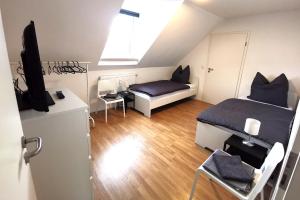a small bedroom with a bed and a television at Spacious Apartment with Balcony & WiFi in Wetzlar