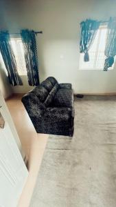 a living room with a couch on the floor at A Home Away From Home in Mawere