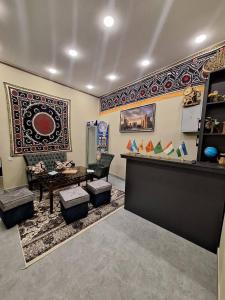 a living room with a table and a rug at Al-Hilal Hostel in Samarkand