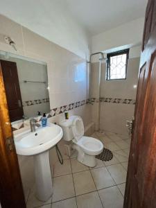 a bathroom with a sink and a toilet at Fully furnished one bedroom apartment in Mombasa VOK off nyali road in Mombasa