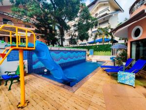 a playground with a slide in a swimming pool at La Sunila 2BHK Presidential Suite by iTvara in Baga