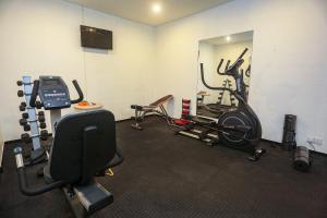 a room with a gym with weights and a mirror at Ilukketiya Tea Chalets in Galle