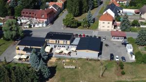 an aerial view of a large house with a garage at Penzion Racek in Tuchlovice