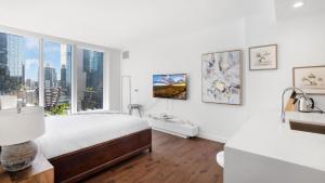 a white bedroom with a bed and a window at Beautiful Bedroom Suite in Manhattan in New York