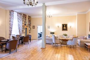 a living room with a couch and tables and chairs at Kloster Hedersleben in Hedersleben