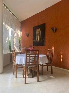 a dining room with a table and chairs and a picture of a dog at Beach front villa in Malindi in Malindi