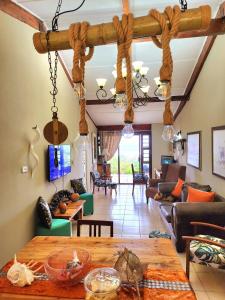 a living room with a wooden ceiling and a table at Seaview Villa 26 in Margate