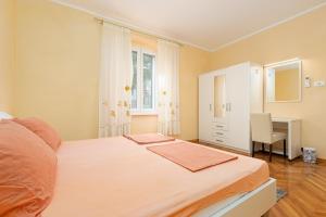 a bedroom with a bed and a desk and a chair at Valnea - apartment for five people in the center of Poreč in Poreč