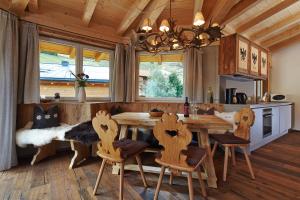 una cucina con un grande tavolo in legno e sedie di A Casa Alpendiamond a Sölden
