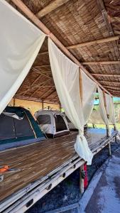 a bed in a tent under a roof at Green smile camping and private beach in Krabi town