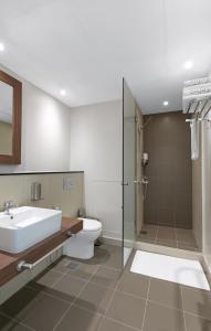 a bathroom with a sink and a toilet and a shower at New fully serviced 1BR Apartment in Al Ain