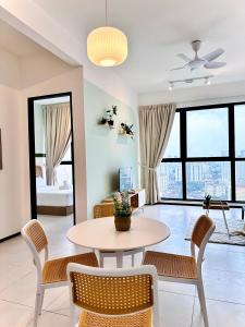 a living room with a table and chairs at Urban Suites Homestay WL in Jelutong