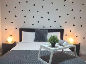 a bedroom with a white bed and a table with a plant at Lux Modern 2BR Radiant Suite+Free Parking in Delta +33 photos