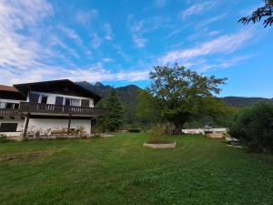 a house with a large yard with a house at Villa Adriana in Tenno