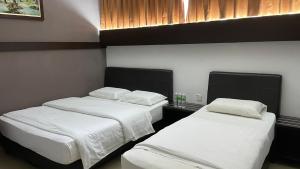 Postel nebo postele na pokoji v ubytování GOPENG INN