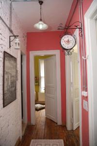a room with red walls and a clock on the wall at Jumba Hostel in Istanbul