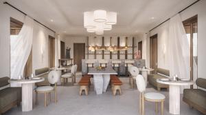 un restaurant avec des tables et des chaises dans l'établissement Anemelia Hotel Mykonos, à Plage d'Élia