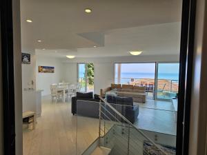 a living room and dining room with a view of the ocean at The blue house, lovely apartment in the Côte d'Azur for 6 people in Menton