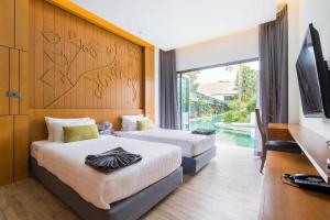 TV a/nebo společenská místnost v ubytování Tajh Pool Villas