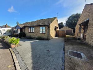 a brick house with a driveway in front of it at Midland Close Bungalow - With separate office space by Catchpole Stays in Colchester