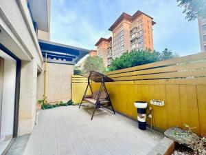 a yellow fence with a tent on a patio at Colorful Yunnan Absolutely Beautiful Dian B&B in Kunming