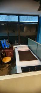 Zimmer mit 2 Betten, einem Schreibtisch und einem Stuhl in der Unterkunft kvm rooms and dormitory in Ernakulam