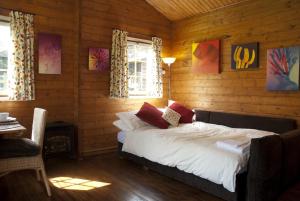a bedroom with a bed in a wooden cabin at ArtHouse B&B in Oakham