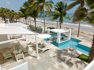 an aerial view of a resort with a pool and the beach at Oceanfront 5-Stars Starfish Villa, Dawn Beach, Private Pool, Secured, Concierge in Oyster Pond