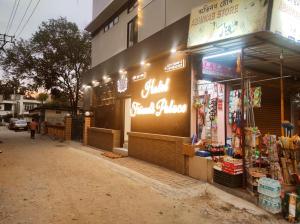 una tienda con letreros de neón al lado de una calle en Hotel Friends Palace, en Tezpur