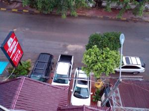 a group of cars parked in a parking lot at Kro Nhep Guesthouse in Kampot
