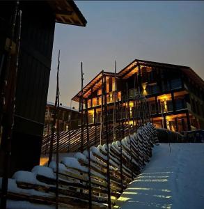 a building with snow in front of it at Kikut Alpin Lodge - Ski in, Ski out in Geilo